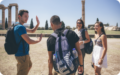 Students hanging around a monument, having fun