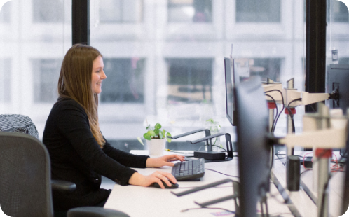 A woman at a desk smiling 