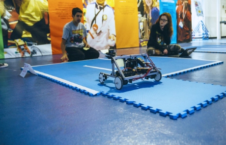 A student interacts with a robot on a class trip to Washington, D.C.