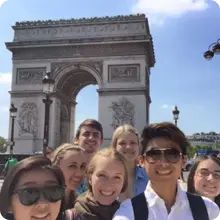 A group of students on a French Language and Culture tour smile and celebrate some of the reasons to learn a new language