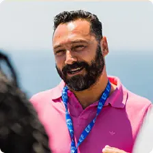 Portrait of a man in a pink polo shirt: Tour Director Artin, who may lead students on our new tour “Epic Greece”
