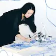 A photo of award-winning artist Sougwen Chung, who studies the art of science by creating work that explores the similarities of human and machine communication